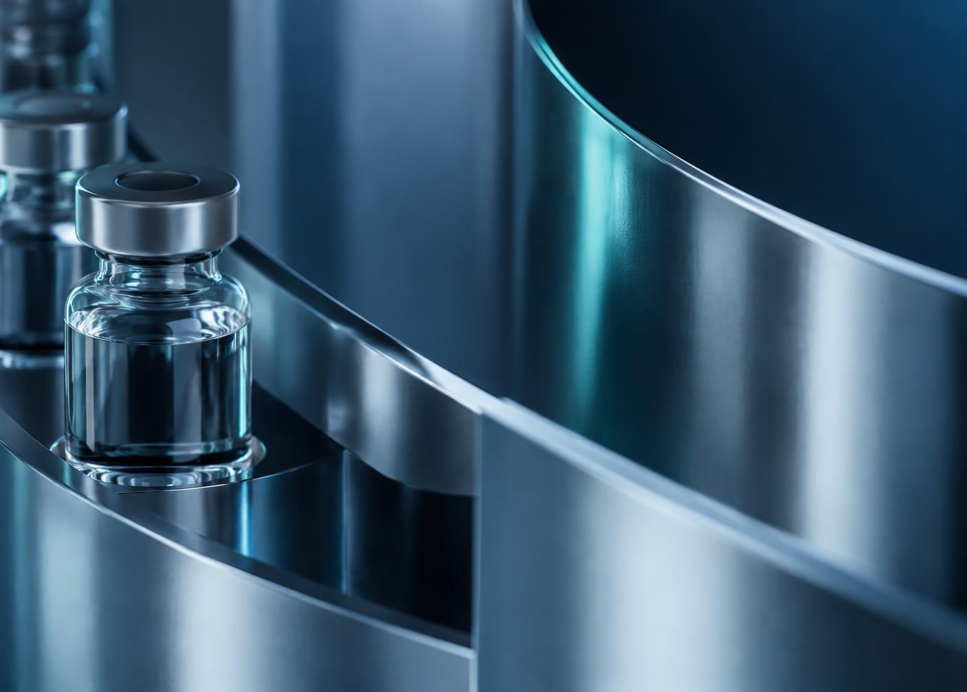 Sealed pharmaceutical vial on polished stainless steel processing equipment